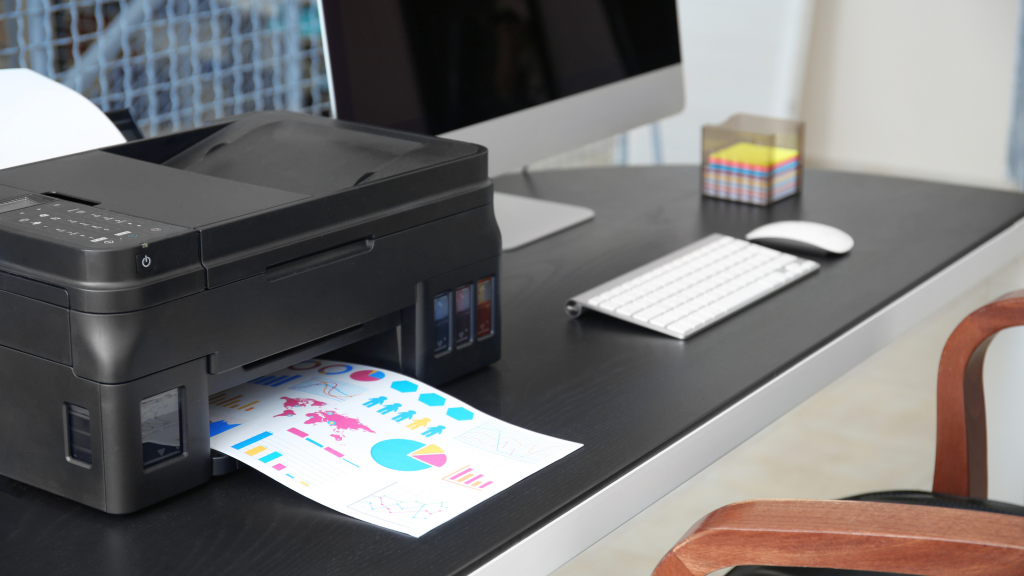 A printer on a table printing a document.